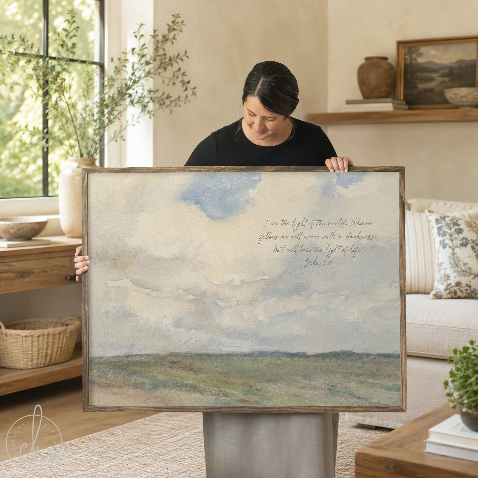  A framed landscape art print with a gold frame. The artwork depicts a watercolor scene of a field under a cloudy sky. The text "I am the light of the world..." is written on the upper right.