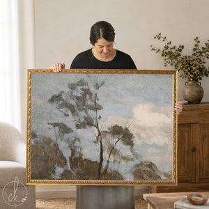 Framed landscape art featuring a moody tree scene with a grey sky, in an ornate gold frame, ready to hang.