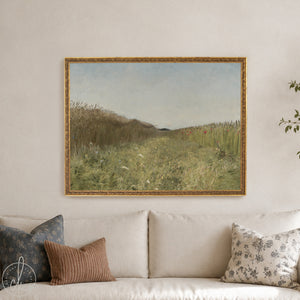 Framed landscape art of a countryside meadow with wildflowers and soft sky.
