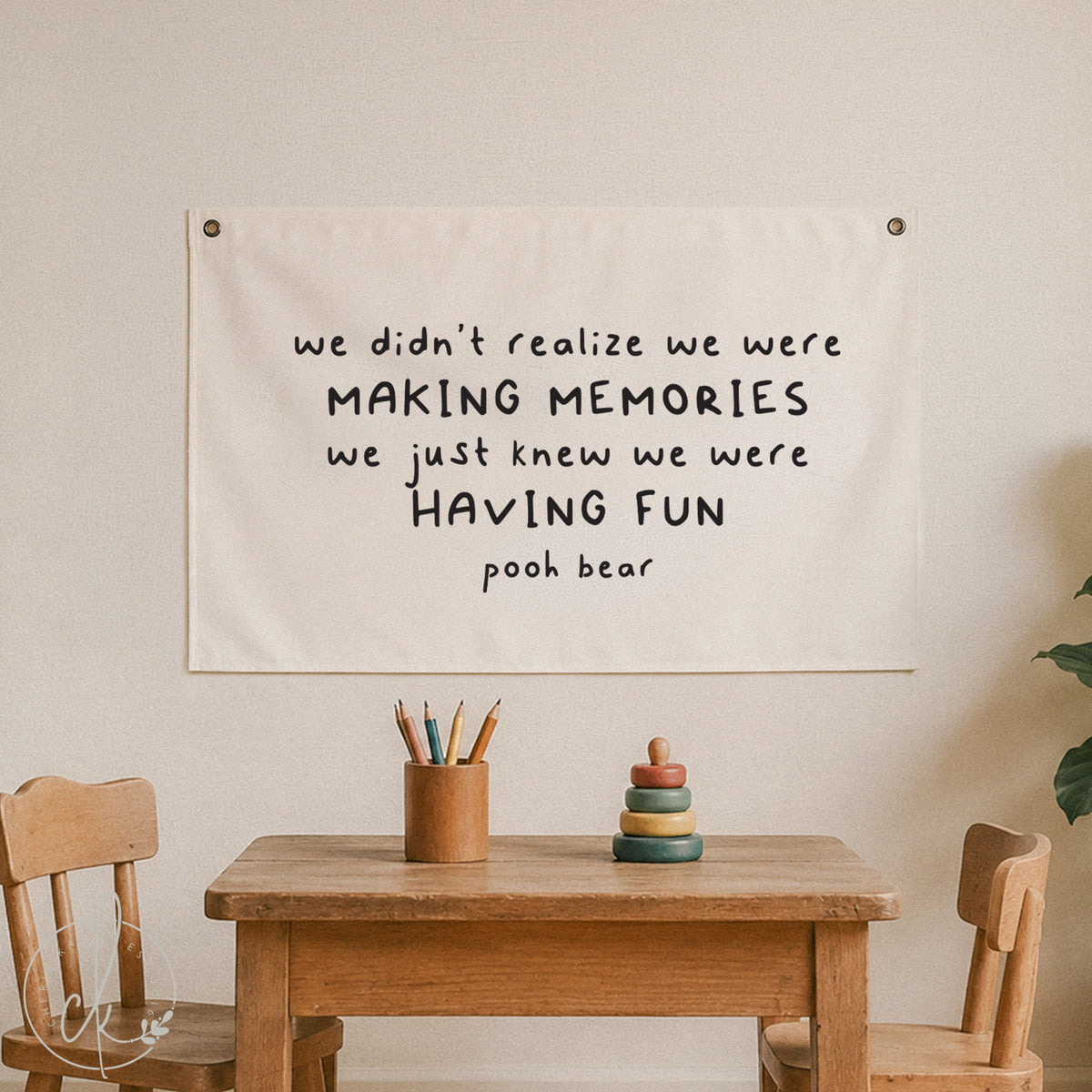 Canvas wall sign with Pooh Bear quote - we didn’t realize we were making memories, we just knew we were having fun - displayed in a cozy kids' room with wooden chairs, table, and soft toys, perfect for nursery, playroom, or children's decor.