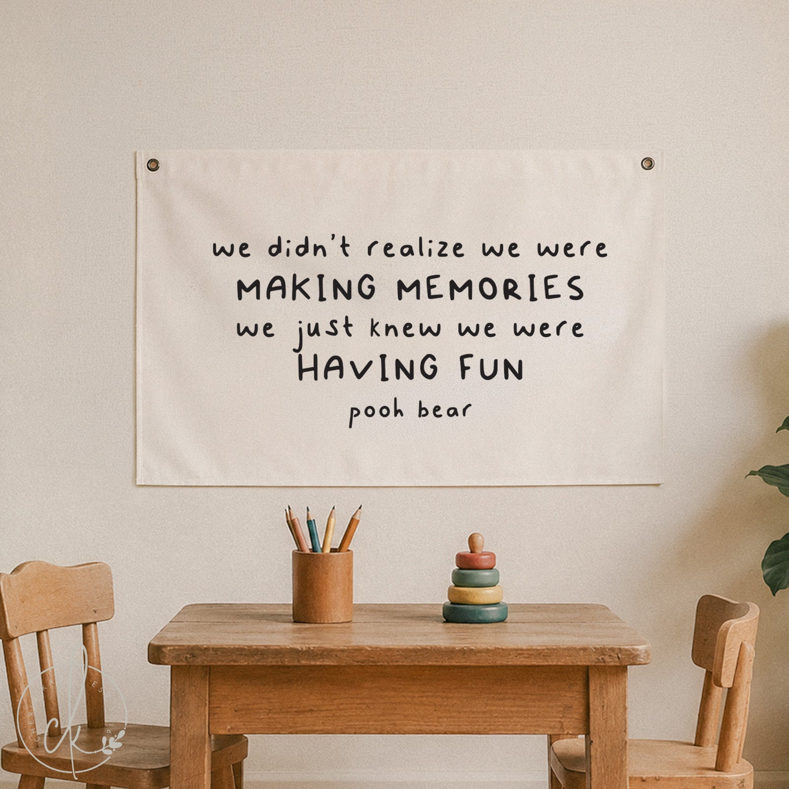 Canvas wall sign with Pooh Bear quote - we didn’t realize we were making memories, we just knew we were having fun - displayed in a cozy kids' room with wooden chairs, table, and soft toys, perfect for nursery, playroom, or children's decor.