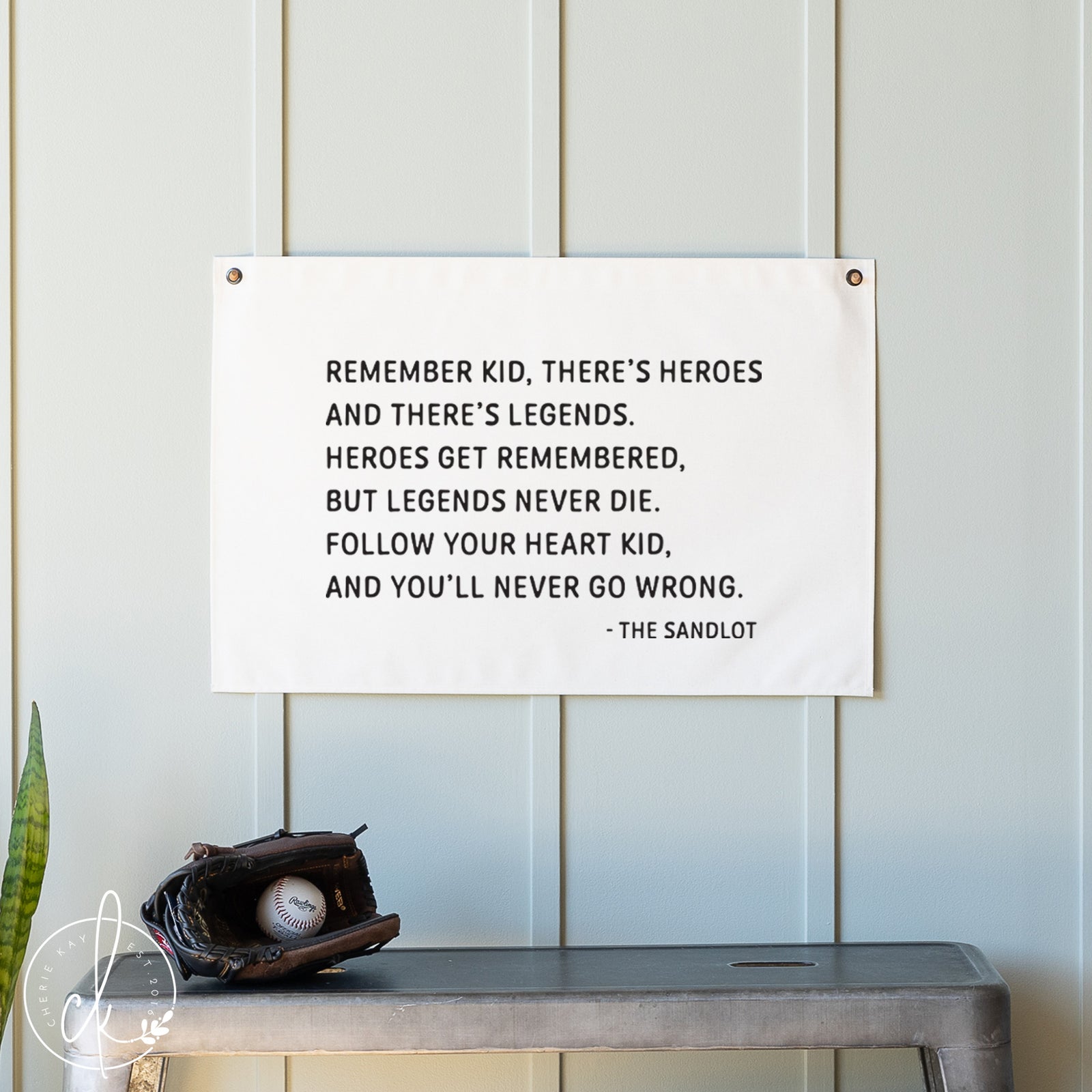 Quote from 'The Sandlot' on a white wall with a baseball glove and ball below.