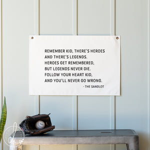 Quote from 'The Sandlot' on a white wall with a baseball glove and ball below.