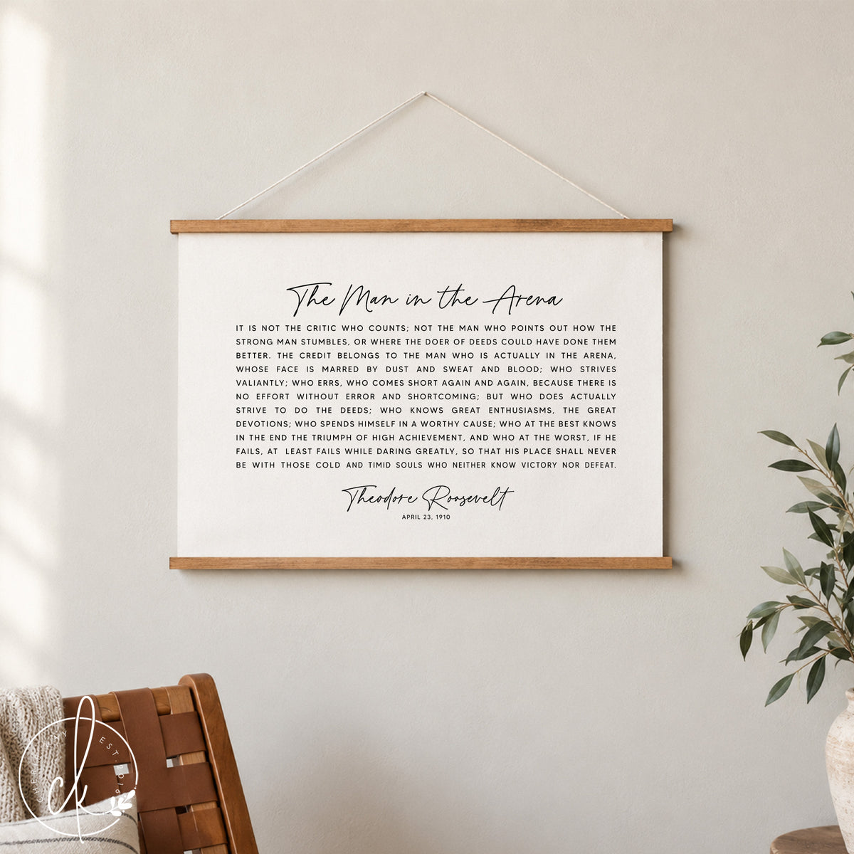 A black and white inspirational quote by Theodore Roosevelt, "The Man in the Arena", printed on a canvas tapestry. The quote is about the importance of taking action and striving for greatness, even in the face of failure.