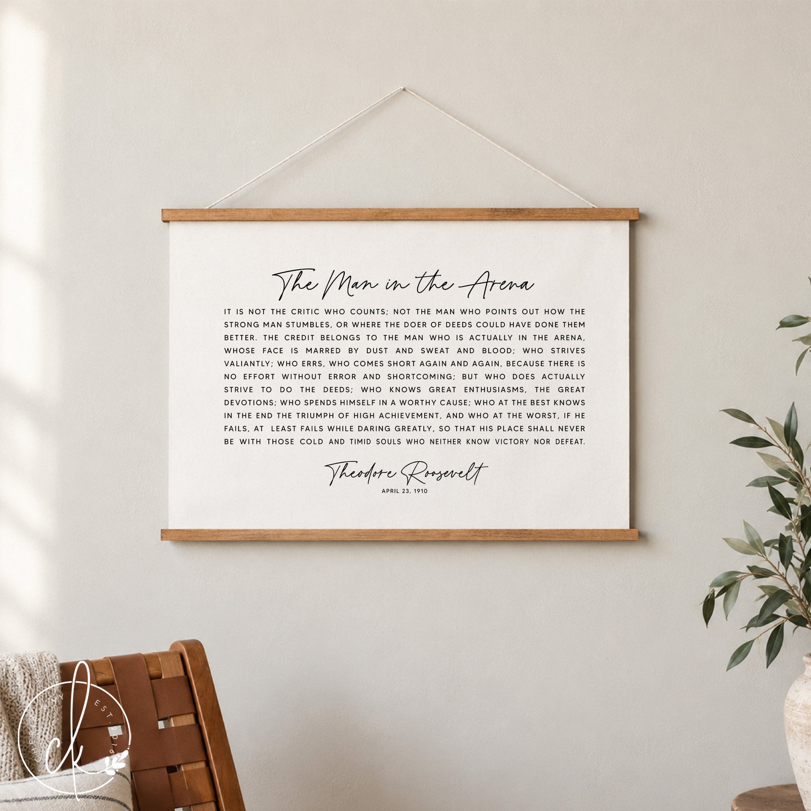 A black and white inspirational quote by Theodore Roosevelt, "The Man in the Arena", printed on a canvas tapestry. The quote is about the importance of taking action and striving for greatness, even in the face of failure.