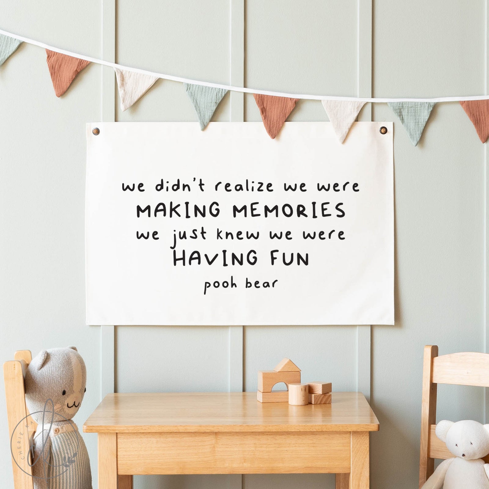 Children's room with a quote poster, wooden table, and toys.