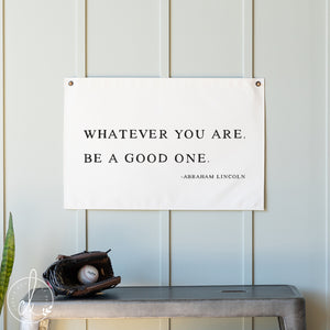 Motivational poster with quote by Abraham Lincoln on a wall with a baseball and glove below.