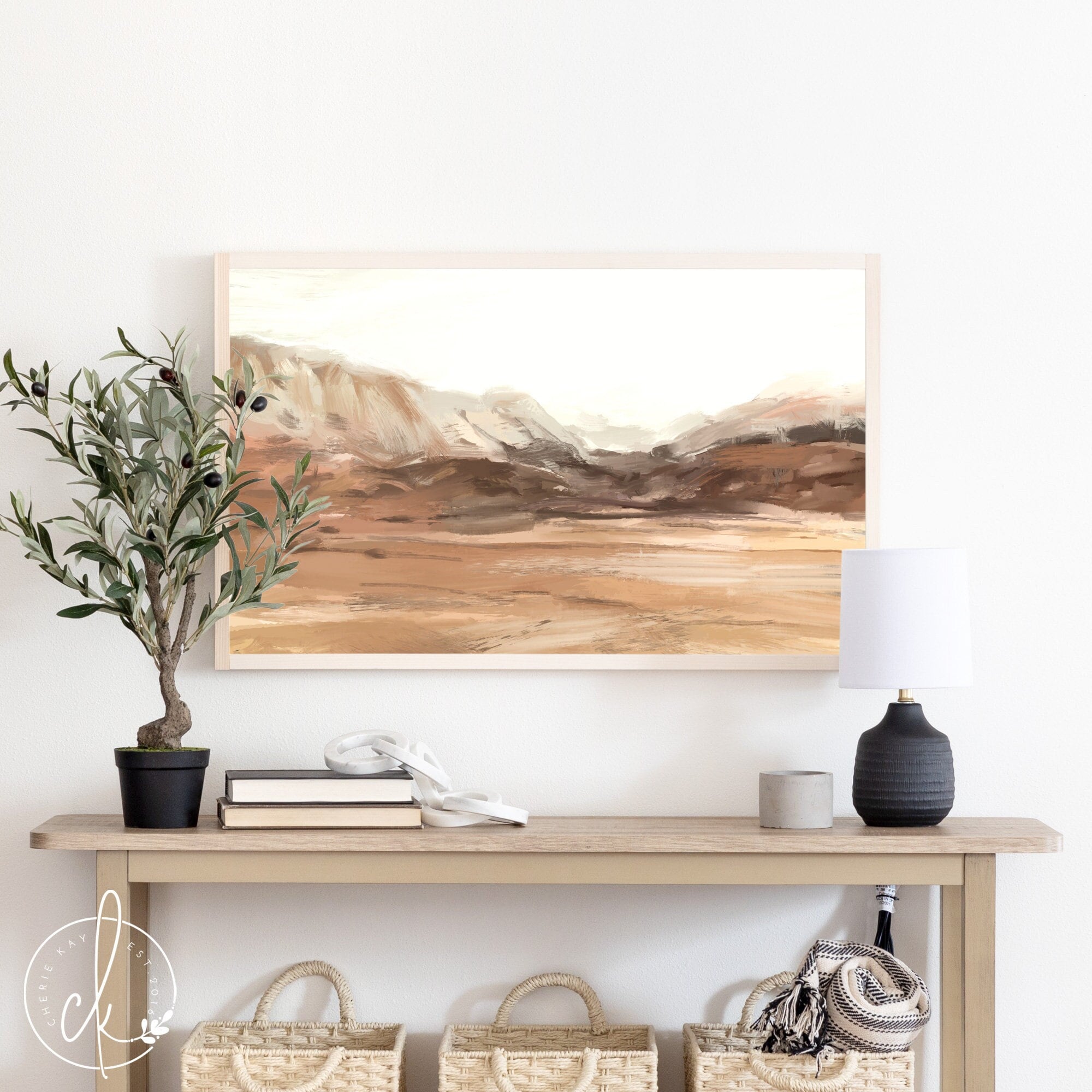 This is an abstract painting of a desert landscape. The painting is printed on wood and framed with a pine frame. The painting is displayed above a table with beautiful home decor.